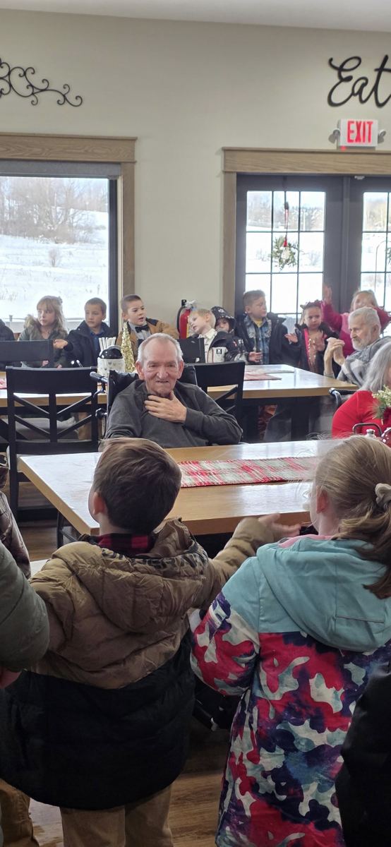 Children singing Christmas carols for residents
